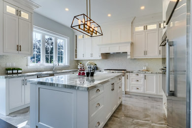 Inspiration for a large transitional u-shaped separate kitchen in Toronto with an undermount sink, shaker cabinets, white cabinets, quartzite benchtops, white splashback, stone tile splashback, stainless steel appliances, marble floors, with island, grey floor and grey benchtop.