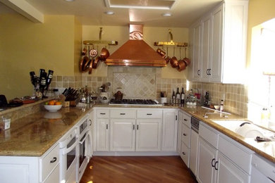 Kitchen - contemporary kitchen idea in San Francisco with raised-panel cabinets and white cabinets