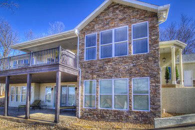 Traditional two-story stone exterior home idea in Other
