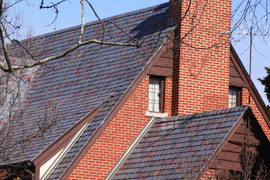 Inspiration for a large traditional two-storey brick red exterior in Wichita with a gable roof.