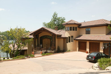 Huge mountain style beige three-story stucco exterior home photo in Kansas City