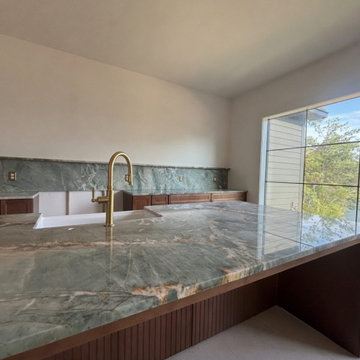 Green quartzite kitchen with full-height slab backsplash