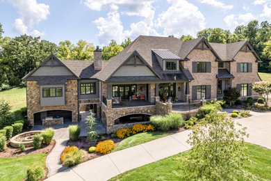Huge transitional three-story mixed siding and shingle exterior home photo in Nashville