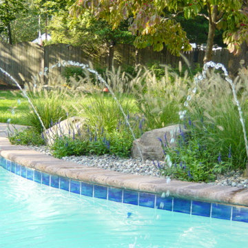 Ornamental Grasses fill rock beds along pool edge
