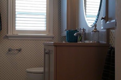 Elegant bathroom photo in Other with recessed-panel cabinets, beige cabinets, a one-piece toilet, a drop-in sink and quartz countertops