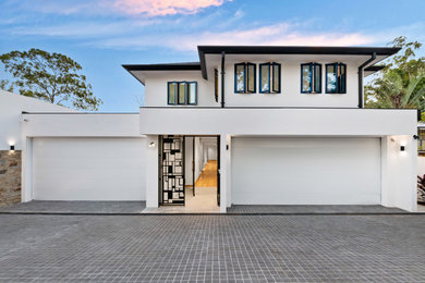 Design ideas for a large modern front door in Brisbane with white walls, a double front door, a black front door and grey floor.