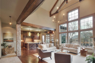 Inspiration for a large transitional open concept family room in Dallas with beige walls, dark hardwood floors, a standard fireplace, a stone fireplace surround and a freestanding tv.