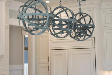 Inspiration for a transitional kitchen remodel in Other with an undermount sink, recessed-panel cabinets, white cabinets, marble countertops, white backsplash, mosaic tile backsplash, stainless steel appliances and an island