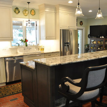 Brush-stroke painted kitchen with red brick floor