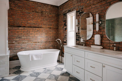 Freestanding bathtub - transitional brick wall freestanding bathtub idea in Detroit