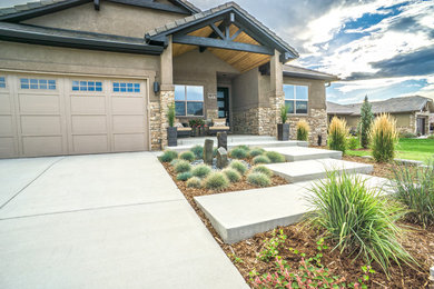 This is an example of a large transitional drought-tolerant and full sun backyard concrete paver water fountain landscape in Denver for summer.