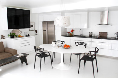 Trendy concrete floor open concept kitchen photo in San Francisco with an undermount sink, flat-panel cabinets, stainless steel appliances, no island, quartzite countertops and white backsplash