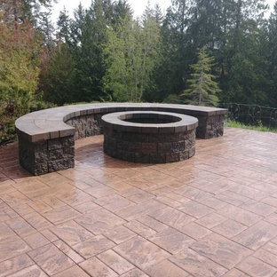 Design ideas for a mid-sized traditional backyard patio in Seattle with a fire feature and concrete pavers.