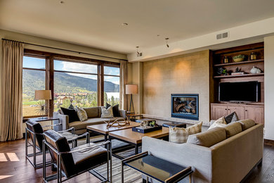 Inspiration for an eclectic open concept carpeted living room remodel in Denver with a standard fireplace, a stone fireplace and a media wall