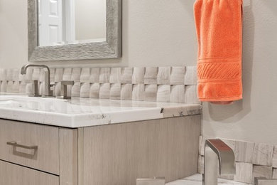 Large minimalist master gray tile and stone tile porcelain tile and multicolored floor bathroom photo in Los Angeles with flat-panel cabinets, gray cabinets, a one-piece toilet, gray walls, an undermount sink and quartzite countertops