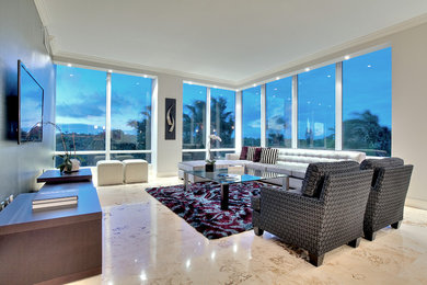 This is an example of a large contemporary open concept family room in Miami with grey walls, no fireplace, a wall-mounted tv and marble floors.