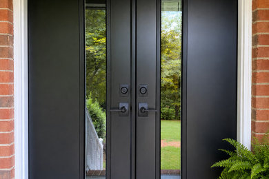 Double front door - traditional double front door idea in Raleigh with a black front door