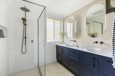Inspiration for a mid-sized modern 3/4 bathroom in Sydney with shaker cabinets, blue cabinets, a corner shower, gray tile, a vessel sink, grey floor, a hinged shower door, white benchtops, a niche, a double vanity and a built-in vanity.