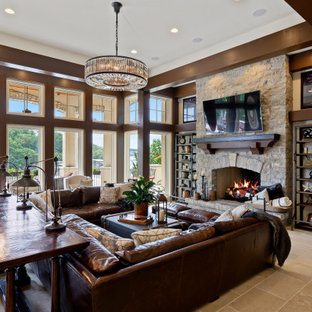 Mediterranean walk-out basement in Kansas City with white walls, a standard fireplace, a stone fireplace surround and beige floors.
