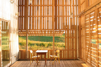 Farmhouse porch idea in Minneapolis with decking