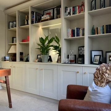 Bespoke cabinets and bookshelves with lit mirror