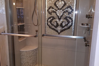 Example of a minimalist master beige tile bathroom design in Cleveland with gray walls, granite countertops and black countertops