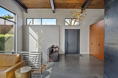 Mid-sized concrete floor, gray floor and exposed beam entryway photo in Seattle with white walls