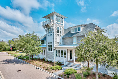 Inspiration for a coastal gray three-story exterior home remodel in Miami
