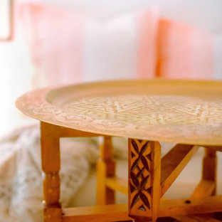 Inspiration for a small contemporary open plan home cinema in New York with white walls, painted wood flooring, a wall mounted tv and black floors.