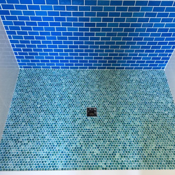 Blue hand made glass tile in the pool bath