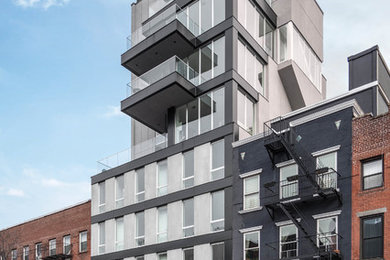 Diseño de fachada gris moderna de tres plantas con tejado plano