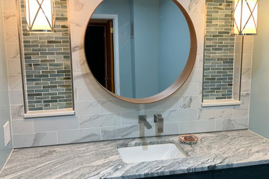 Inspiration for a mid-sized 1950s master gray tile and porcelain tile single-sink bathroom remodel in St Louis with glass-front cabinets, black cabinets, granite countertops, gray countertops and a floating vanity