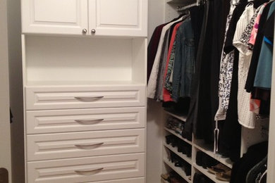 Photo of a mid-sized traditional gender-neutral walk-in wardrobe in Boston with open cabinets, white cabinets and light hardwood floors.