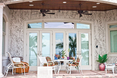 Inspiration for a small contemporary backyard concrete paver patio remodel in Tampa with a roof extension
