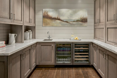 Inspiration for a transitional medium tone wood floor enclosed kitchen remodel in Chicago with an undermount sink, raised-panel cabinets, marble countertops and stainless steel appliances