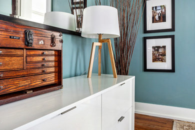 Inspiration for a small transitional master medium tone wood floor bedroom remodel in Other with blue walls