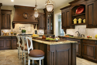 Elegant kitchen photo in New York with an undermount sink, raised-panel cabinets, dark wood cabinets and beige backsplash