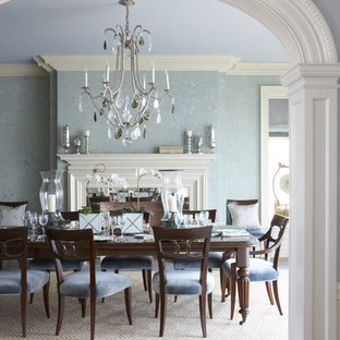 Idées déco pour une grande salle à manger classique fermée avec un mur bleu, un sol beige, un sol en bois brun, une cheminée standard et un manteau de cheminée en bois.