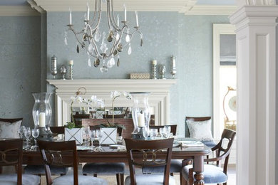 Enclosed dining room - large traditional beige floor and medium tone wood floor enclosed dining room idea in New York with blue walls, a standard fireplace and a wood fireplace surround