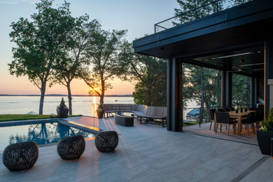 Inspiration for a large modern backyard tile patio remodel in Minneapolis with no cover