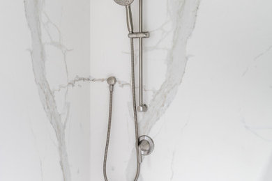 Example of a mid-sized transitional master white tile and stone slab double-sink bathroom design in Seattle with shaker cabinets, beige cabinets, solid surface countertops, white countertops and a built-in vanity