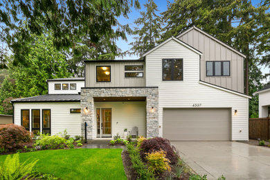 Huge farmhouse multicolored two-story wood and clapboard exterior home idea in Seattle with a metal roof and a black roof