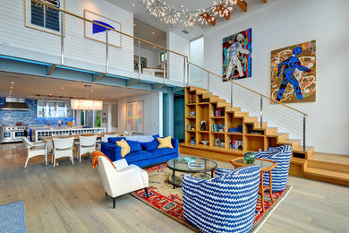 Huge beach style open concept light wood floor living room photo in Los Angeles