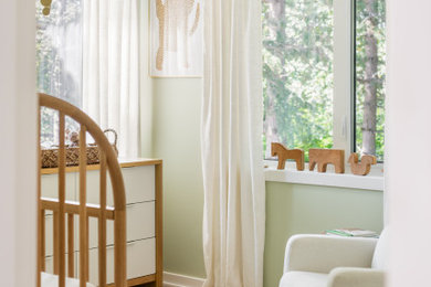 Eclectic light wood floor nursery photo in Other with green walls