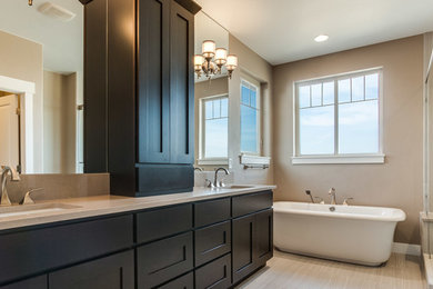 Bathroom - mid-sized transitional master porcelain tile bathroom idea in Denver with dark wood cabinets, shaker cabinets, beige walls, an undermount sink and quartz countertops