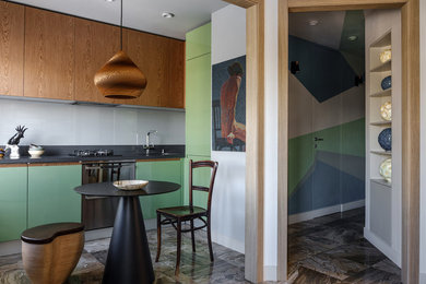 Inspiration for a contemporary brown floor eat-in kitchen remodel in Moscow with flat-panel cabinets, green cabinets, stainless steel appliances, black countertops, an undermount sink, gray backsplash and glass sheet backsplash