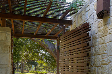 Trendy one-story stone exterior home photo in Austin with a shed roof