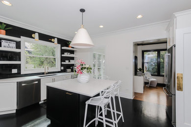 Eat-in kitchen - mid-sized transitional u-shaped black floor eat-in kitchen idea in Chicago with an undermount sink, raised-panel cabinets, white cabinets, quartzite countertops, black backsplash, porcelain backsplash, stainless steel appliances, an island and white countertops