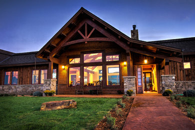 Example of a large mountain style brown one-story wood gable roof design in Other