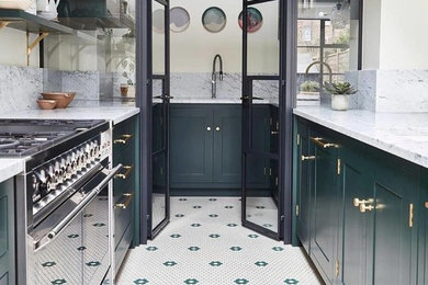 Inspiration for a traditional u-shaped enclosed kitchen in London with shaker cabinets, green cabinets, grey splashback and grey worktops.